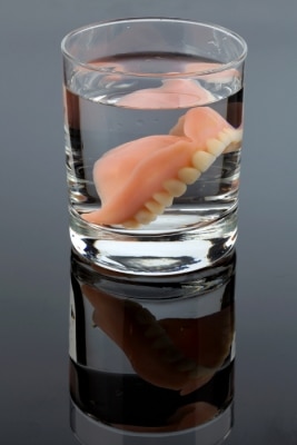 dentures sitting in water glass